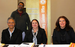 Session Moderator, Father Matsepane Morare (Behind) with speakers for the day: (From Left) Mr Farrel Hunter (Country Director, DVV International), Ms Ruschda O' Shea (Principal, Tafelsig High School) and Ms Robyn Beere (IESA)